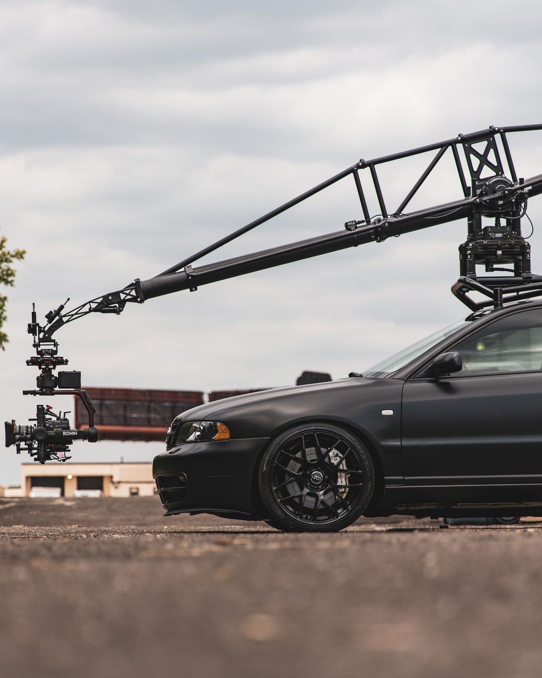 MotoCrane camera rig on a matte black Audi S4