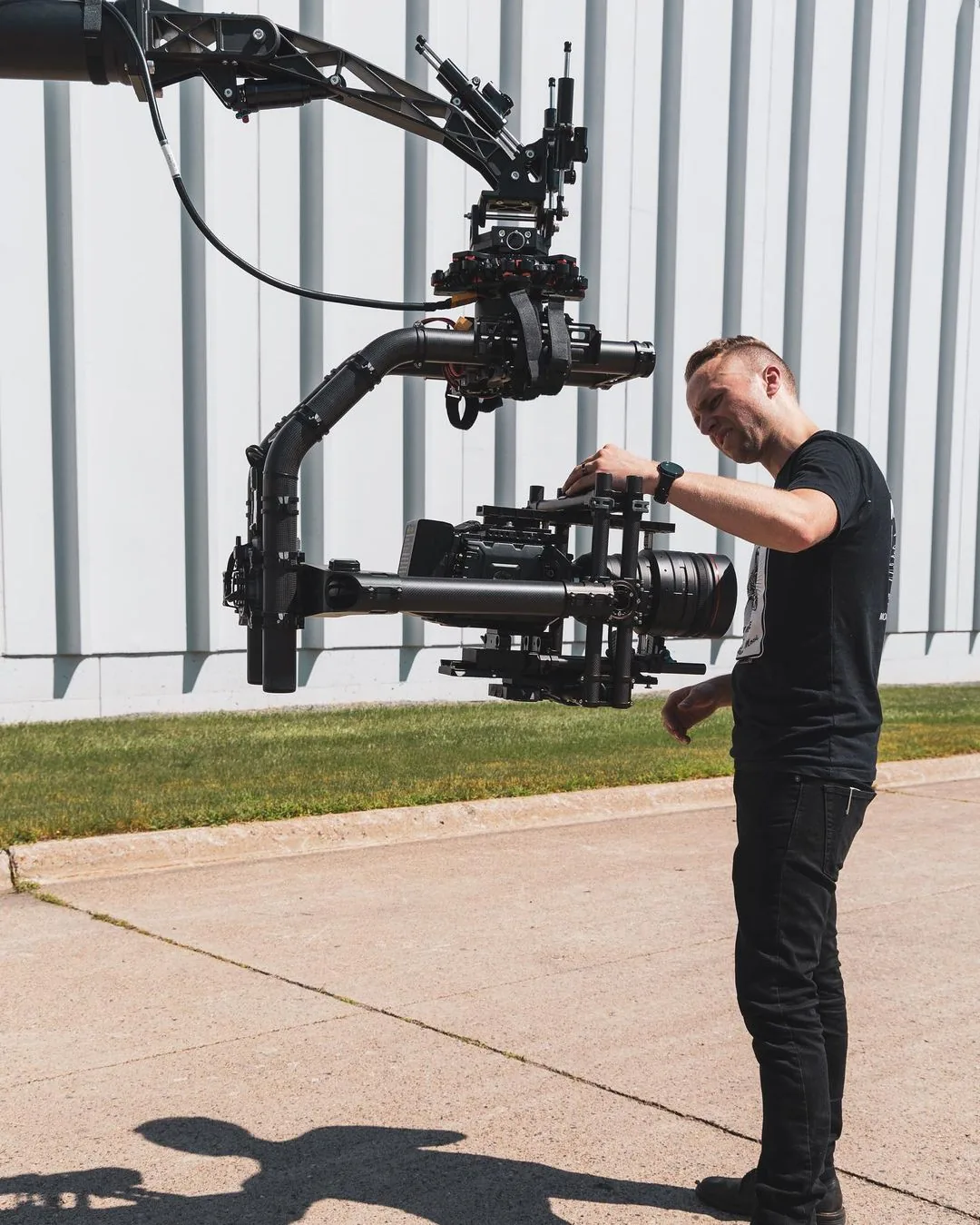 Operator setting up a gimbal-mounted cinema camera