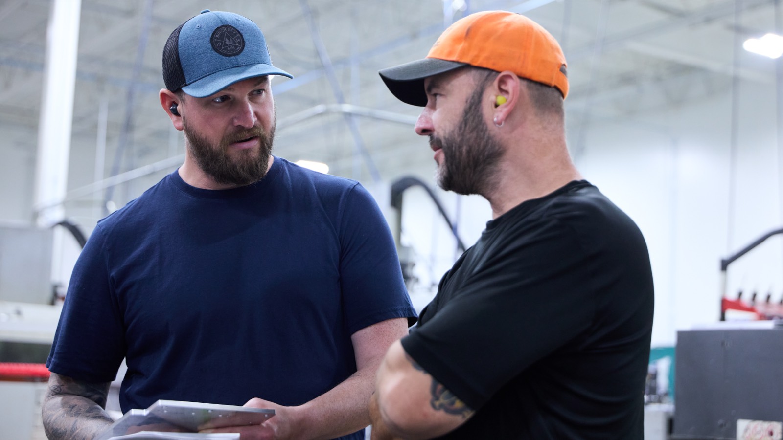 Two Taylor Machine team members talking on the shop floor
